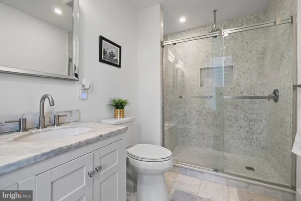 a bathroom with a sink toilet and shower
