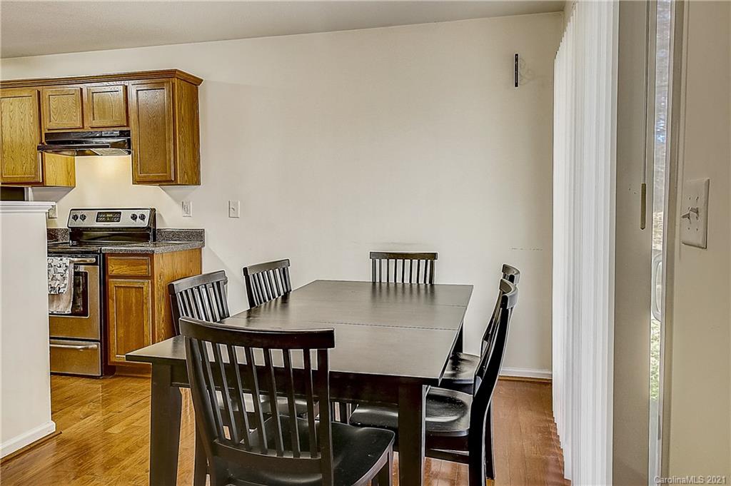 7029 Sunman Road Charlotte, NC 28216 - Photo 11 of 33 a view of a dining room with furniture and wooden floor