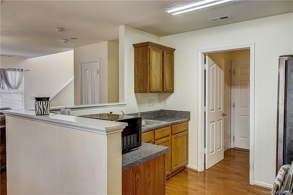 7029 Sunman Road Charlotte, NC 28216 - Photo 13 of 33 a view of a kitchen counter space and wooden floor