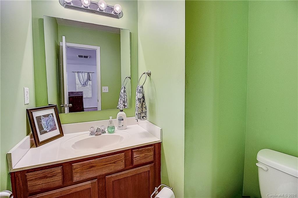 7029 Sunman Road Charlotte, NC 28216 - Photo 16 of 33 a bathroom with a sink and a mirror