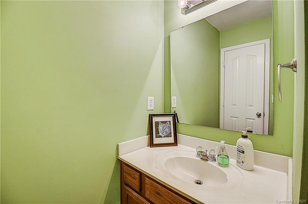 7029 Sunman Road Charlotte, NC 28216 - Photo 17 of 33 a bathroom with a sink and a mirror