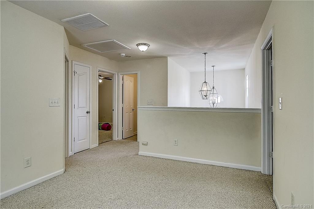 7029 Sunman Road Charlotte, NC 28216 - Photo 21 of 33 an empty room with a empty space and windows