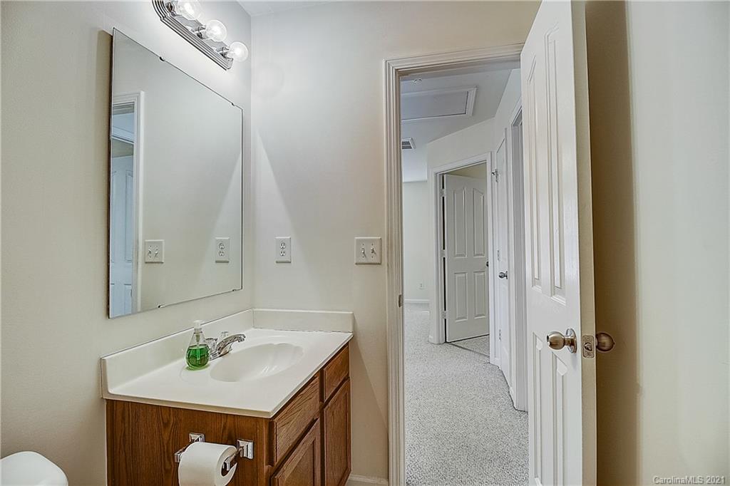 7029 Sunman Road Charlotte, NC 28216 - Photo 23 of 33 a bathroom with a sink vanity and mirror