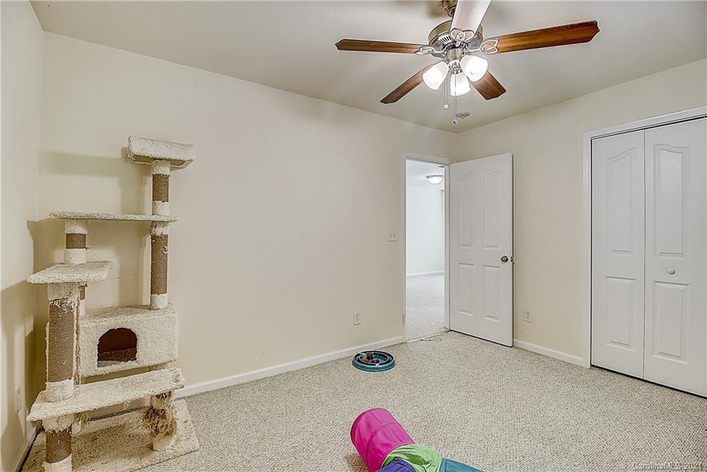 7029 Sunman Road Charlotte, NC 28216 - Photo 25 of 33 a very nice looking room with a ceiling fan