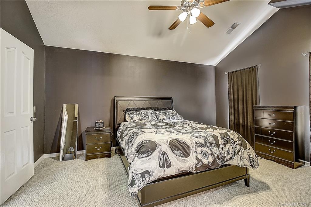7029 Sunman Road Charlotte, NC 28216 - Photo 28 of 33 a bedroom with a bed and a television