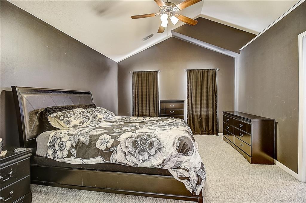 7029 Sunman Road Charlotte, NC 28216 - Photo 29 of 33 a bedroom with a large bed and a tv