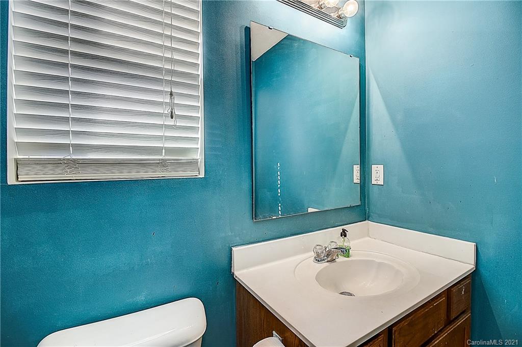 7029 Sunman Road Charlotte, NC 28216 - Photo 31 of 33 a bathroom with a sink a toilet and a mirror