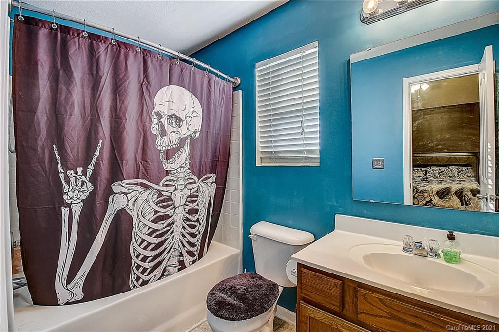 7029 Sunman Road Charlotte, NC 28216 - Photo 32 of 33 a bathroom with a sink and a mirror