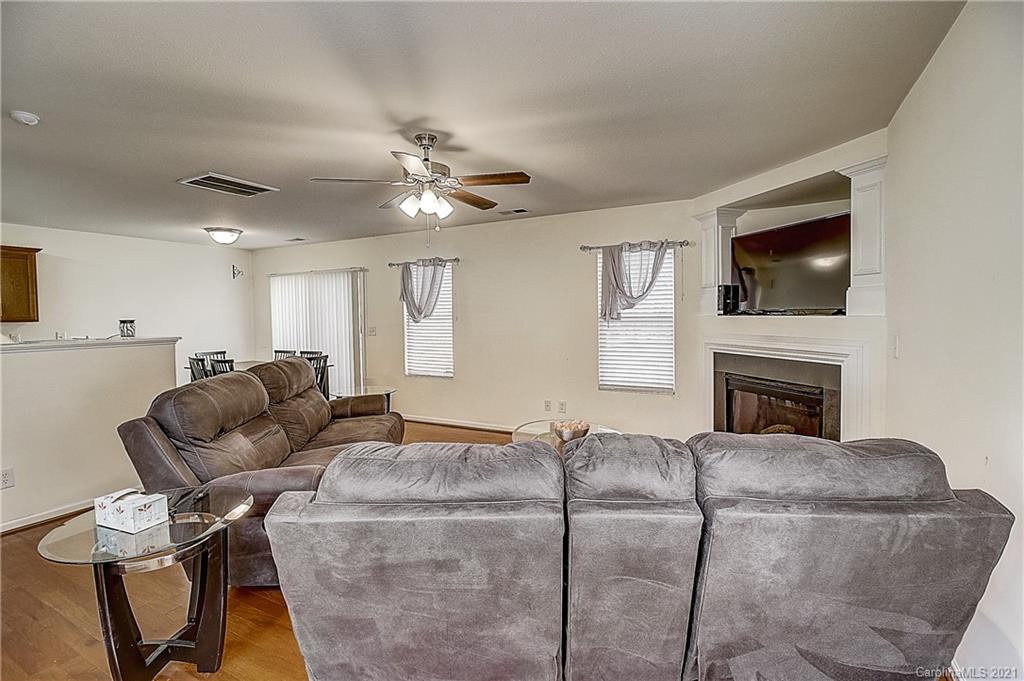 7029 Sunman Road Charlotte, NC 28216 - Photo 5 of 33 a living room with furniture a flat screen tv and a fireplace