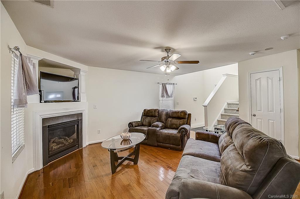 7029 Sunman Road Charlotte, NC 28216 - Photo 7 of 33 a living room with furniture and a fireplace