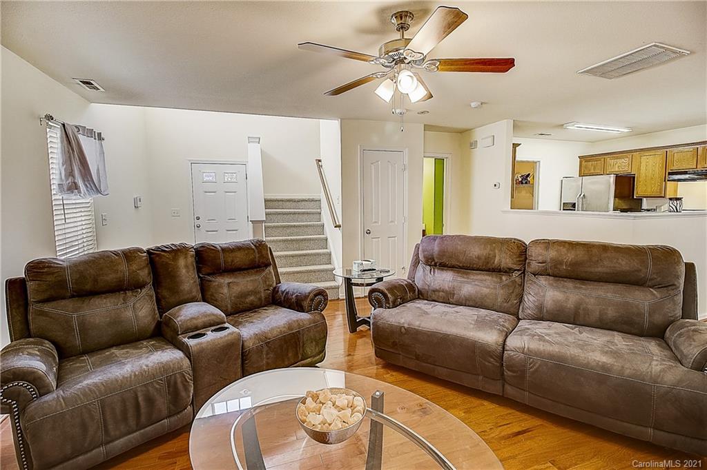 7029 Sunman Road Charlotte, NC 28216 - Photo 9 of 33 a living room with furniture a large window and a chandelier