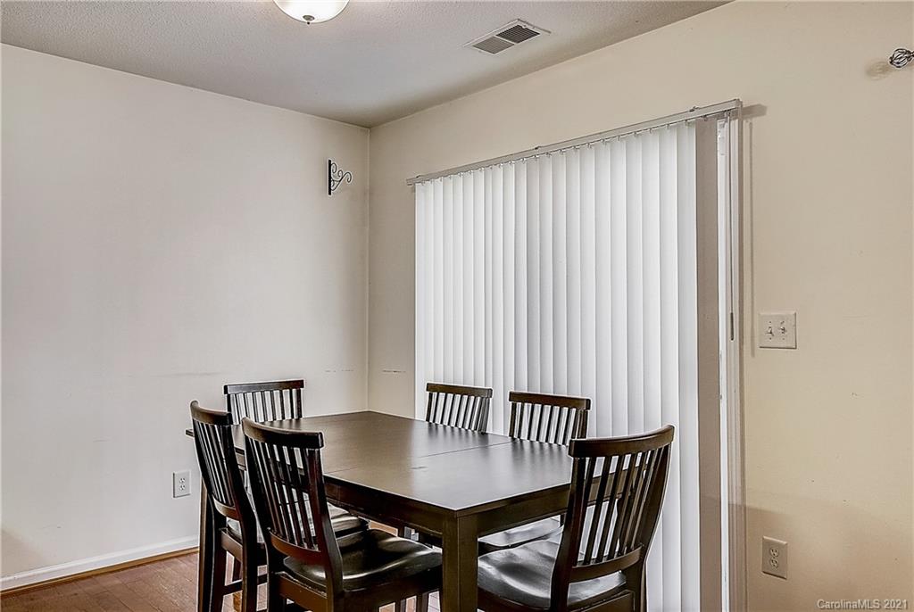7029 Sunman Road Charlotte, NC 28216 - Photo 10 of 33 a view of a dining room with furniture and wooden floor