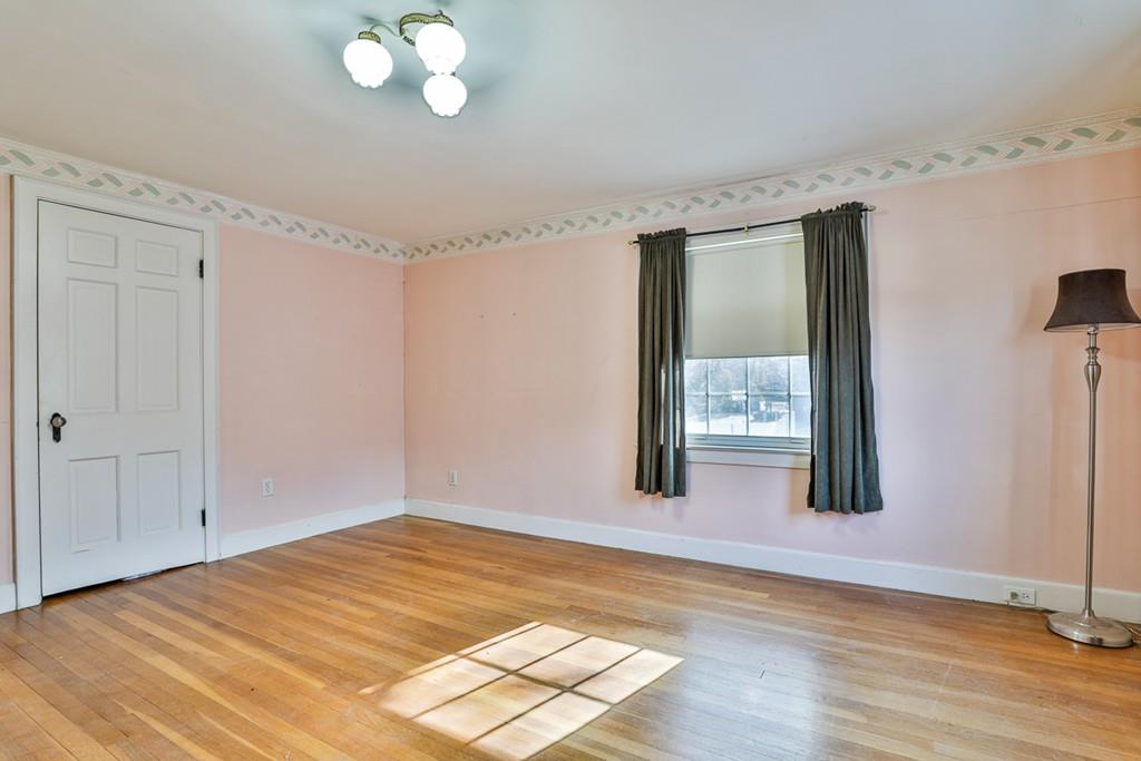 554 Brook Road Milton, MA 02186 - Photo 14 of 22 a view of an empty room with wooden floor and a window