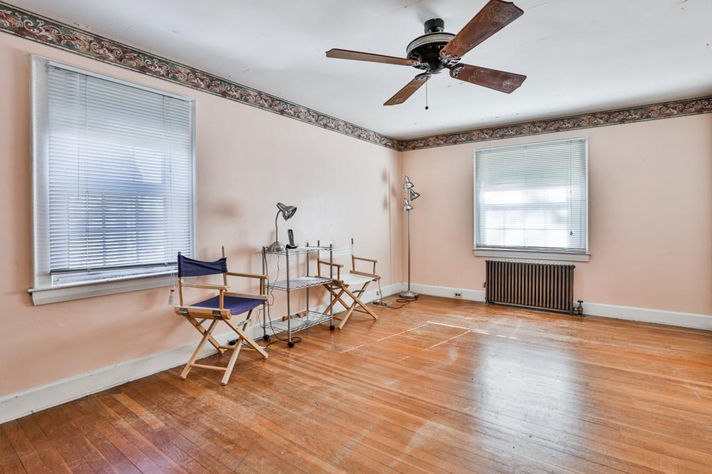 554 Brook Road Milton, MA 02186 - Photo 16 of 22 a view of an empty room with a window and wooden floor