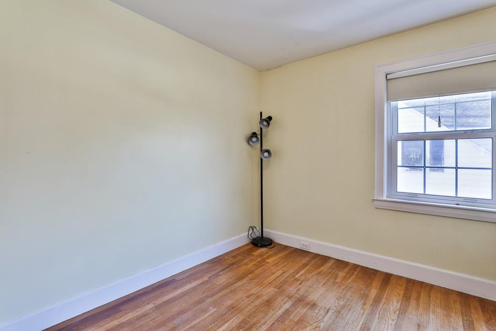 554 Brook Road Milton, MA 02186 - Photo 18 of 22 a view of empty room with wooden floor and fan