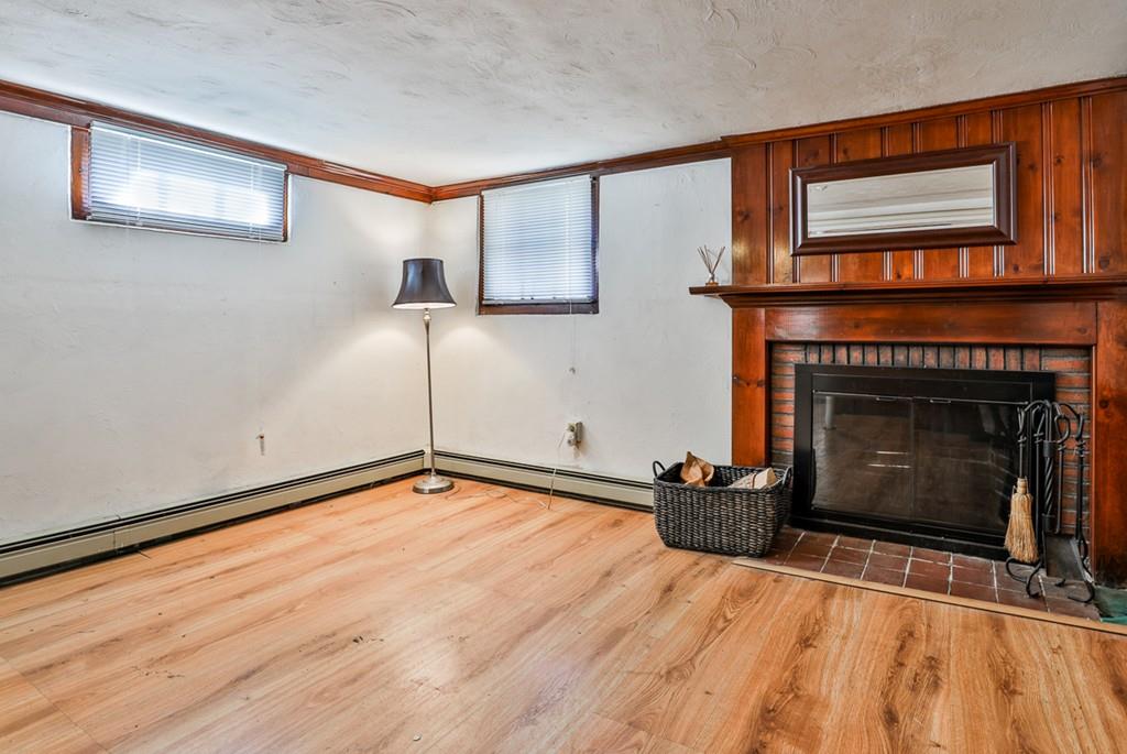 554 Brook Road Milton, MA 02186 - Photo 20 of 22 a bedroom with a bed and a fireplace