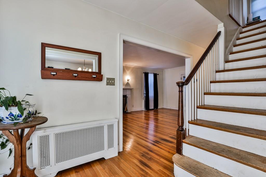 554 Brook Road Milton, MA 02186 - Photo 2 of 22 a view of a hallway with wooden floor and stairs