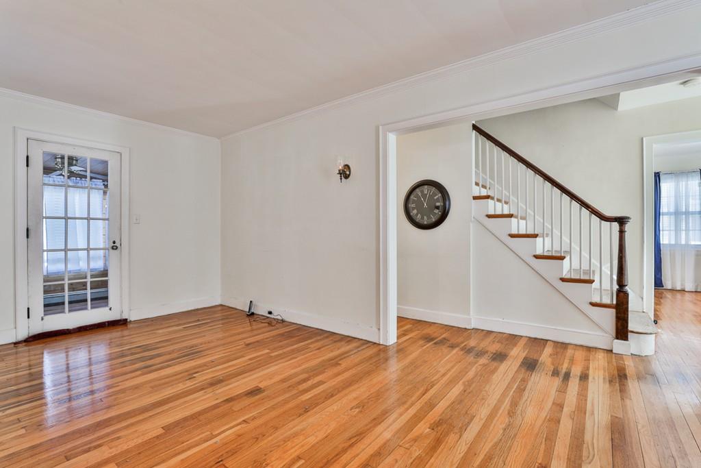 554 Brook Road Milton, MA 02186 - Photo 4 of 22 a view of an empty room with wooden floor and a window