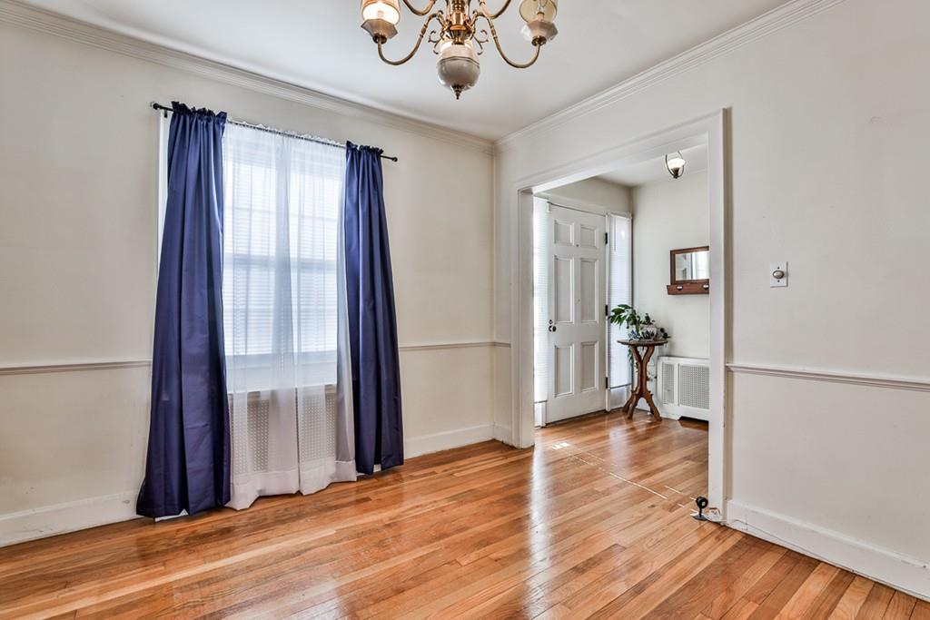 554 Brook Road Milton, MA 02186 - Photo 6 of 22 a view of empty room with wooden floor