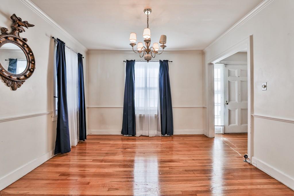 554 Brook Road Milton, MA 02186 - Photo 7 of 22 a view of a room with wooden floor and chandelier