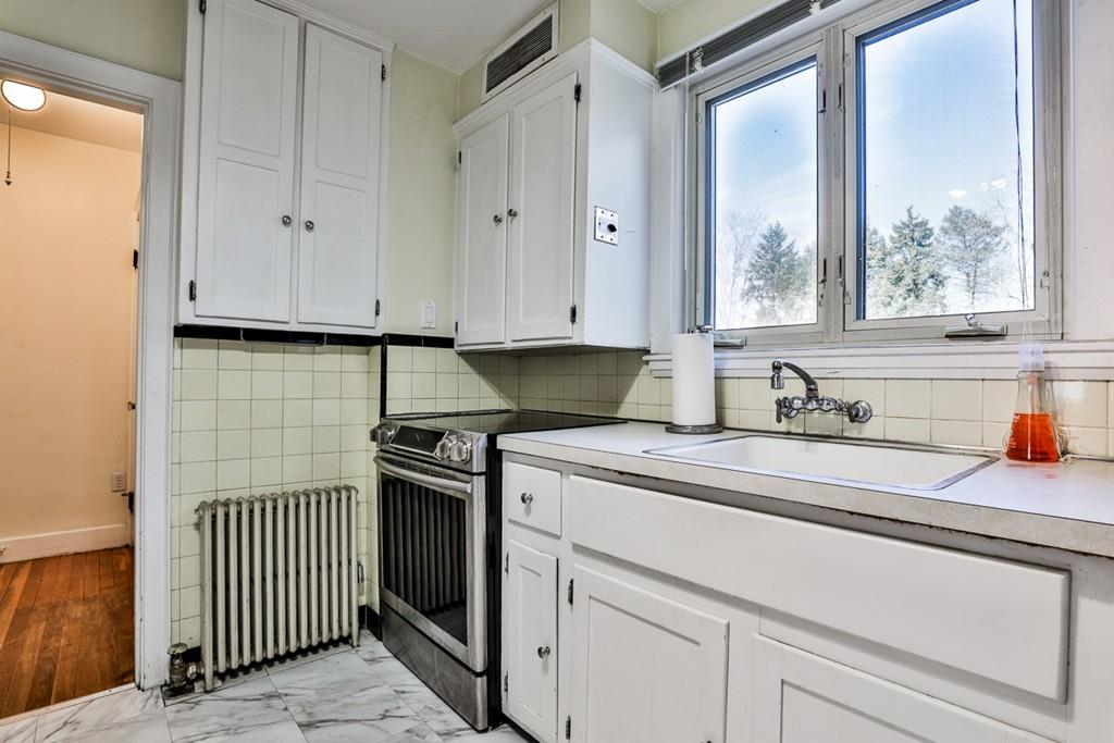 554 Brook Road Milton, MA 02186 - Photo 10 of 22 a kitchen with stainless steel appliances granite countertop white cabinets and a sink