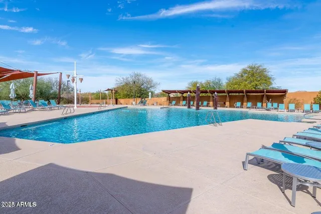 a view of a swimming pool with an outdoor seating