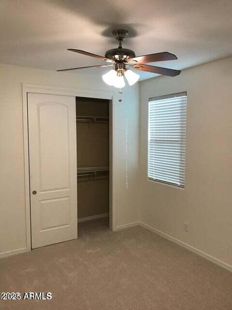 3838 East Cat Balue Drive Phoenix, AZ 85050 - Photo 11 of 22 a view of a livingroom with a ceiling fan and window