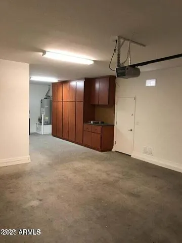 a view of a kitchen with a sink and a refrigerator