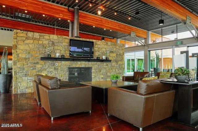 a living room with fireplace furniture and a floor to ceiling window