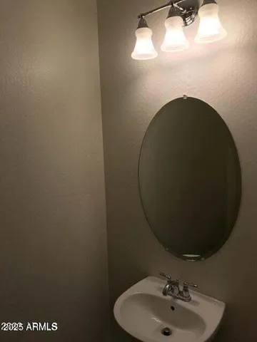 a bathroom with a sink and mirror