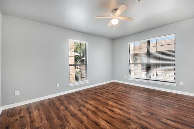 wooden floor in an empty room with a window