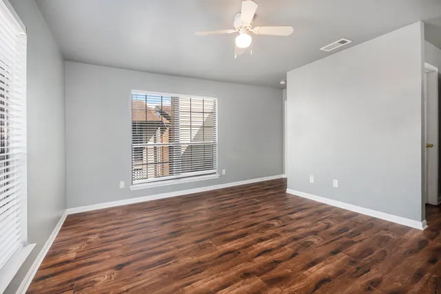a view of a room with wooden floor