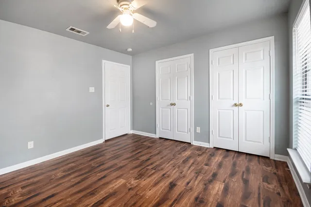 a view of wooden floor and windows in a room