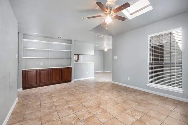 a view of entryway and kitchen with white walls