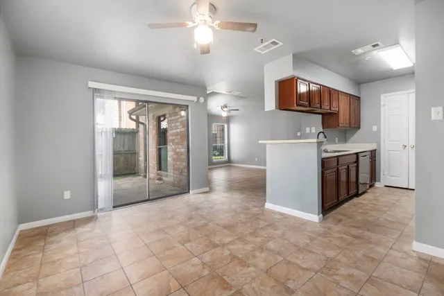 a view of a kitchen with furniture and a ceiling fan