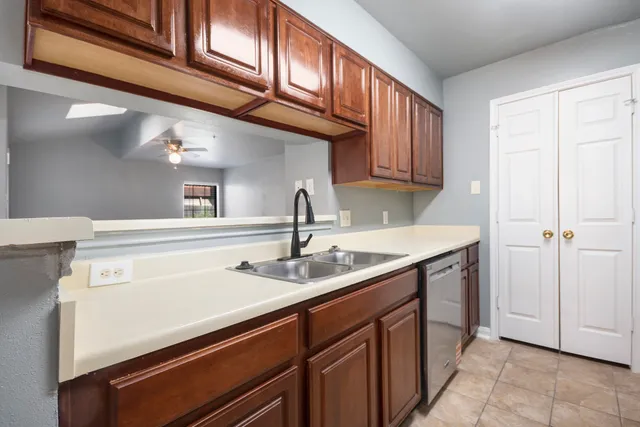 a kitchen with a sink cabinets and a window