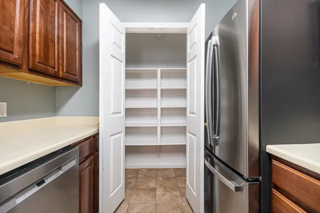 walk in closet with wooden floor