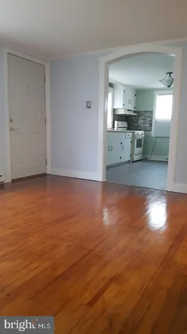 a view of a kitchen with wooden floor and a kitchen