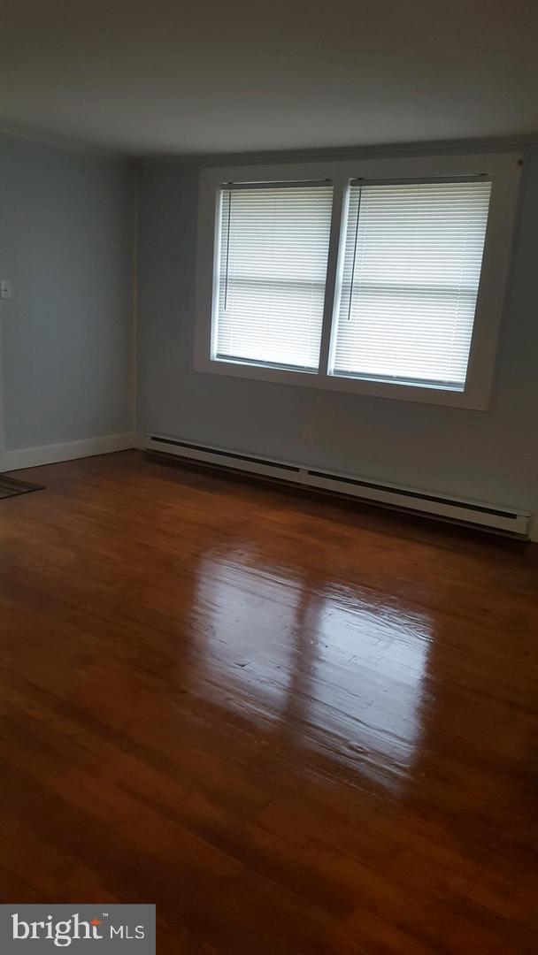 30225 Frankford School Road Frankford, DE 19945 - Photo 3 of 10 an empty room with wooden floor and windows