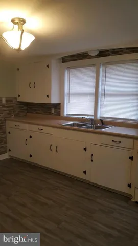 a kitchen with a sink and cabinets