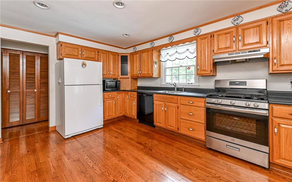 121 Oakglen Road Pittsburgh, PA 15237 - Photo 3 of 30 a kitchen with stainless steel appliances granite countertop a stove a refrigerator and a stove top oven