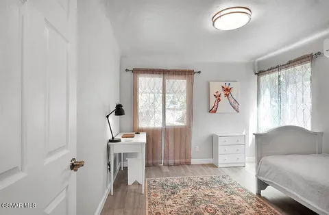a bathroom with a sink toilet and window