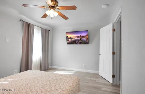 a view of a chair and table in backyard of the house