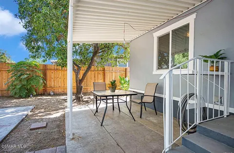 a patio with a table and chairs