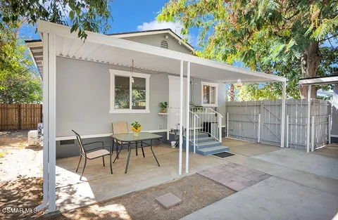 a backyard of a house with garden and trees
