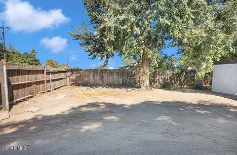 a view of a house with a yard and garage