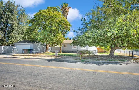 a view of a house with a street
