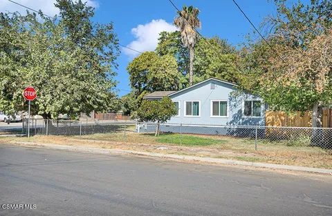 a house with lots of trees in front of it