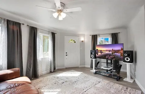 a view of a livingroom with furniture and a window