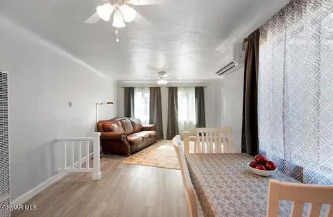 a bedroom with furniture and wooden floor